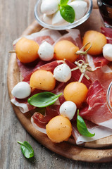 Healthy appetizer with melon, ham and mozzarella