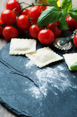 Uncooked ravioli with tomato and basil
