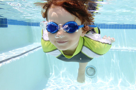 Child Swimming in Pool Underwater