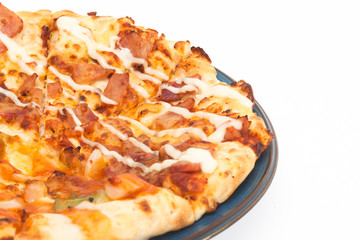 round pizza on blue dish isolated