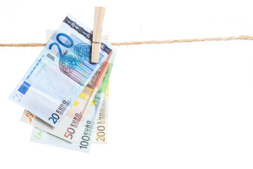 Euro banknotes hanging from a rope