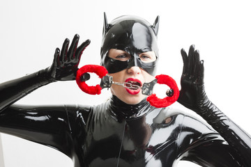 portrait of woman wearing latex clothes with handcuffs
