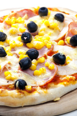 pizza with ham, corn and olives