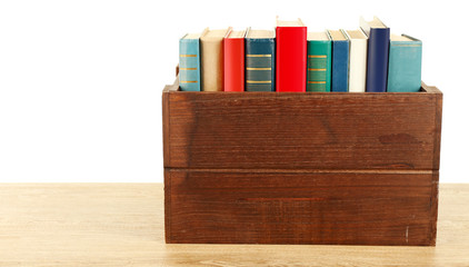 Books in wooden box isolated on white