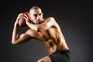 Fototapeta na wymiar Muscular football player with ball