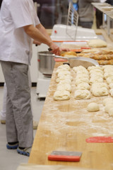 Chefs forming dough in order to prepare bread