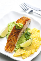 grilled salmon fillet with avocado sauce and nachos