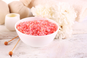 Spa still life with color sea salt on wooden table, closeup