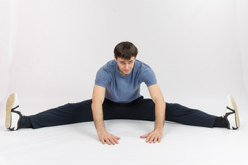 Fototapeta premium Athlete sitting on the splits