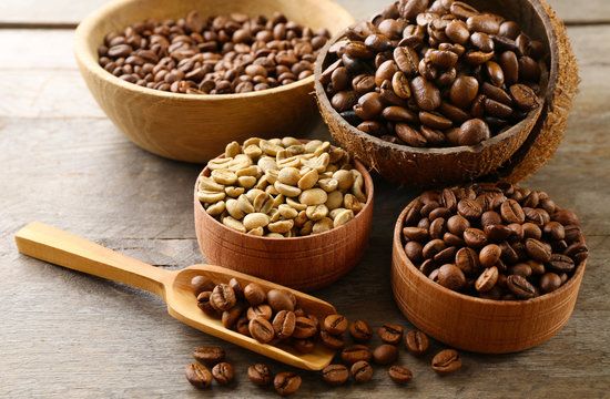Various of coffee in small dishes on wooden table, closeup