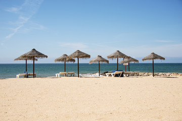 Fototapeta na wymiar tropical parasols on the algarve beach
