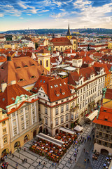 Fototapeta premium Houses with traditional red roofs in Prague Old Town Square in t