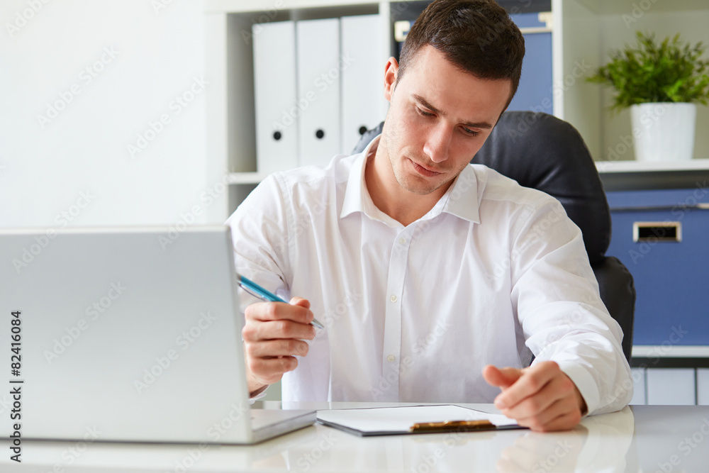 Poster young businessman signs a document