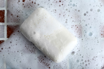 Soap with bubble on mosaic tiles background
