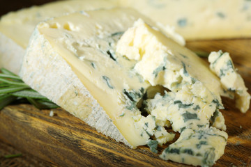 Blue cheese on wooden cutting board. closeup