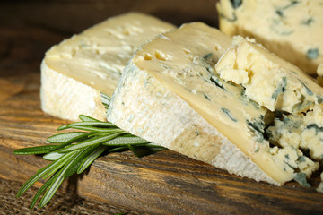 Blue cheese on wooden cutting board. closeup
