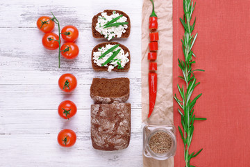 Bread with cottage cheese, greens and tomatoes on table top view
