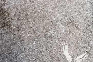 Old wall of concrete chips with cracks.