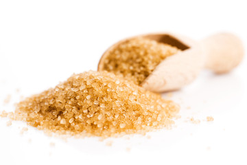 Crystals cane sugar heap close up isolated on white