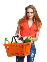 Happy woman holding a basket full of healthy food. Shopping