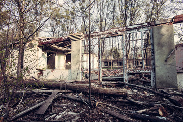 Fototapeta na wymiar Shabby abandoned house with cracked color paint.