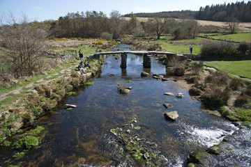 Fototapeta na wymiar Ancient Clapper bridge at Postbrige on Dartmoor Devon UK