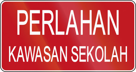 Road sign in Brunei: Perlahan - Kawasan sekolah/Slow down - School area