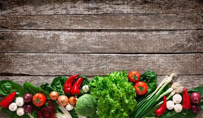 Fresh ripe vegetables on wooden table background