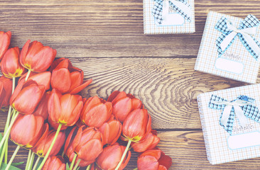 Tulips on Wooden Table with Little Gift Boxes