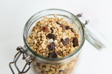 Homemade granola in open glass jar