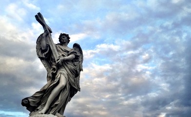 Fototapeta na wymiar statue of an angel holding a cross