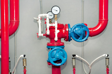 Red pipeline with manometers and blue gauges.