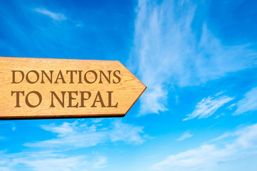 Wooden arrow sign with message DONATIONS TO NEPAL