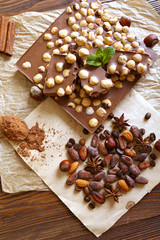 Delicious chocolates with spices on table, closeup