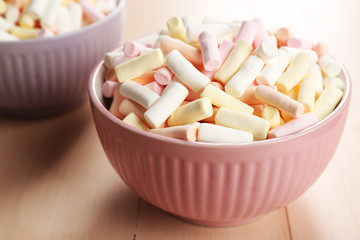 Sweet candies on color wooden table, closeup
