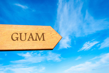 Wooden arrow sign pointing destination GUAM - obrazy, fototapety, plakaty