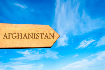 Wooden arrow sign pointing destination AFGHANISTAN
