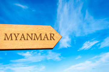 Wooden arrow sign pointing destination MYANMAR
