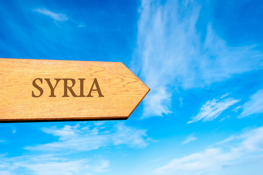 Wooden arrow sign pointing destination SYRIA