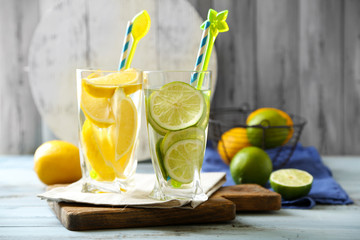Cocktails with fresh citrus fruits on wooden background