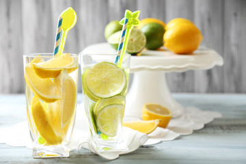 Cocktails with fresh citrus fruits on wooden background