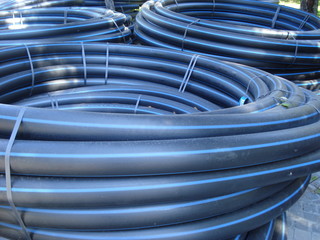 Coiled plastic tubes stored outdoors, before being used