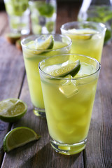 Glasses of cocktails on wooden table, closeup