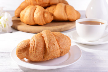 Delicious croissants on plate on table close-up