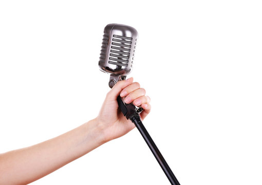 Retro microphone in female hand isolated on white