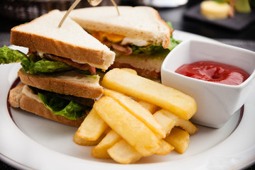 Sandwich with fried eggs, bacon and lettuce
