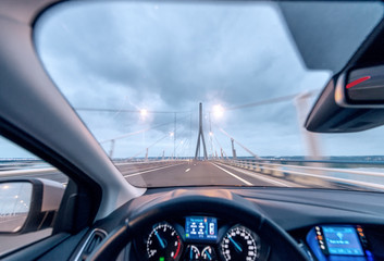 Crossing the bridge with a modern car, cockpit view