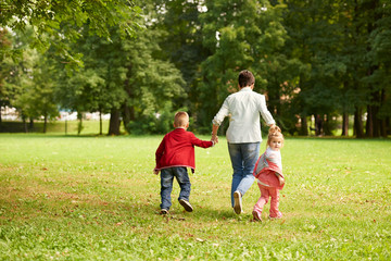 Fototapeta premium happy family playing together outdoor in park