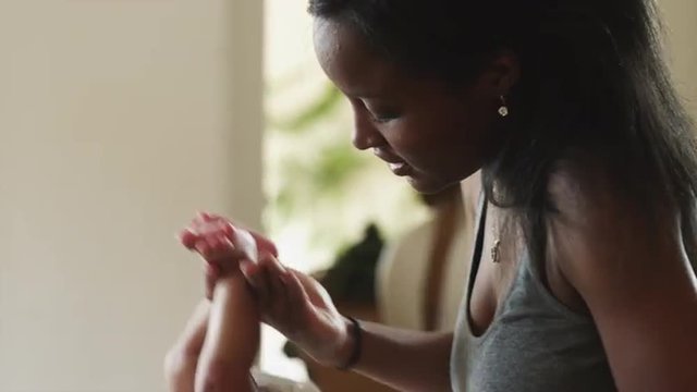 CU TU TD Woman dressing up baby boy (2-5 months) / Cedar Hills, Utah, USA