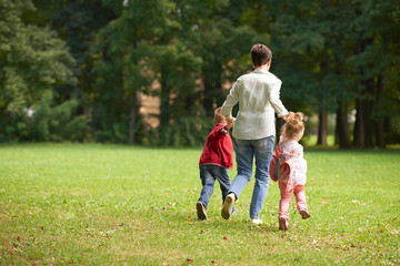 Fototapeta premium happy family playing together outdoor in park